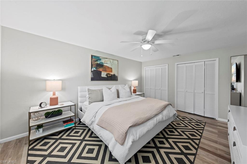 843 Palm View Drive, Unit 25 Naples, FL 34110 - Photo 18 of 27 a bedroom with a bed and a chandelier