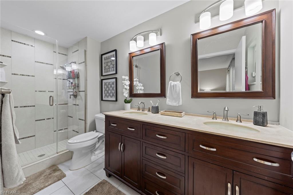843 Palm View Drive, Unit 25 Naples, FL 34110 - Photo 19 of 27 a bathroom with a double vanity sink mirror and toilet