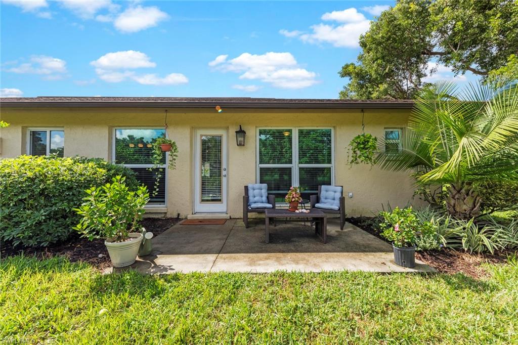 843 Palm View Drive, Unit 25 Naples, FL 34110 - Photo 24 of 27 a view of a house with backyard sitting area and garden