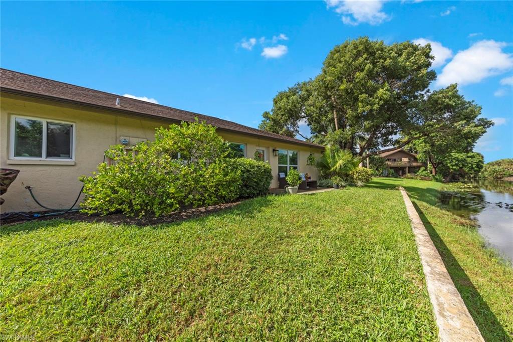 843 Palm View Drive, Unit 25 Naples, FL 34110 - Photo 27 of 27 a view of backyard with swimming pool