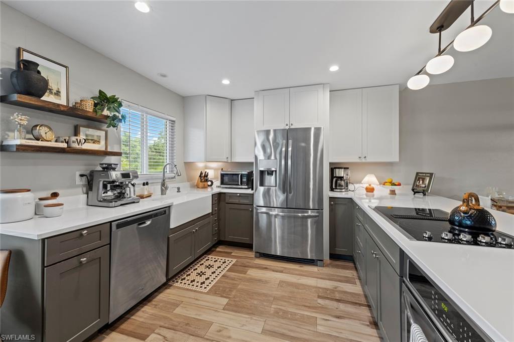 843 Palm View Drive, Unit 25 Naples, FL 34110 - Photo 6 of 27 a kitchen with a sink cabinets and stainless steel appliances