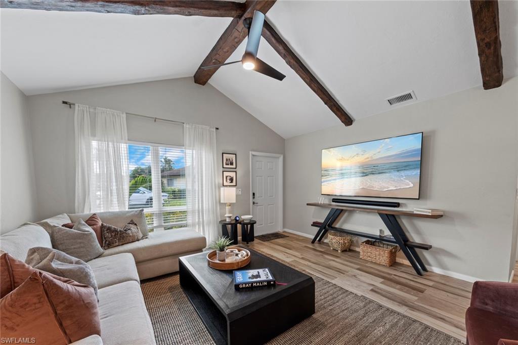 843 Palm View Drive, Unit 25 Naples, FL 34110 - Photo 8 of 27 a living room with furniture and a flat screen tv