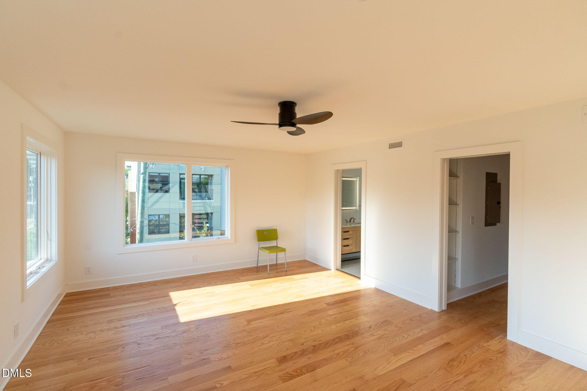 400 East Martin Street, Unit A Raleigh, NC 27601 - Photo 17 of 29 a view of an empty room with wooden floor and a window