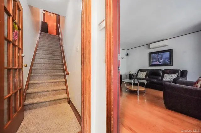 a living room with furniture a flat screen tv and a window