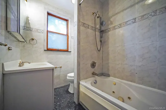 a bedroom with a bed dresser and a window