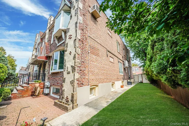 a view of road with card parked on side and retail shops