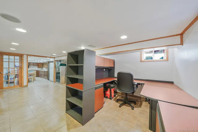 a room with stainless steel appliances a refrigerator and a cabinets