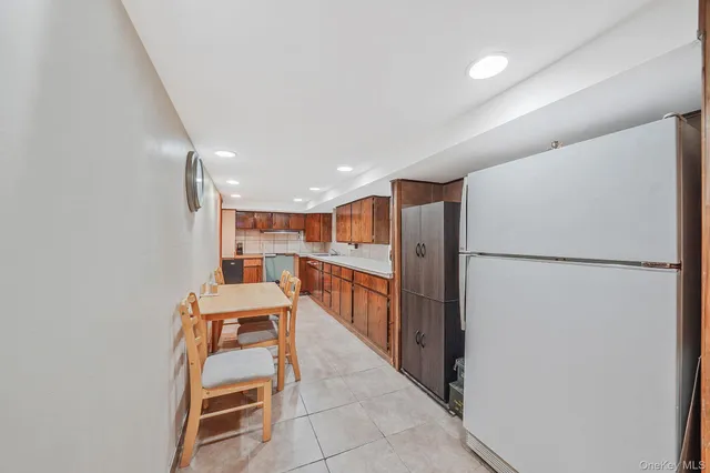 a large kitchen with stainless steel appliances kitchen island granite countertop a sink and cabinets
