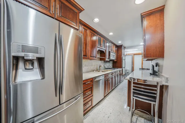 a kitchen with stainless steel appliances granite countertop a sink stove and cabinets