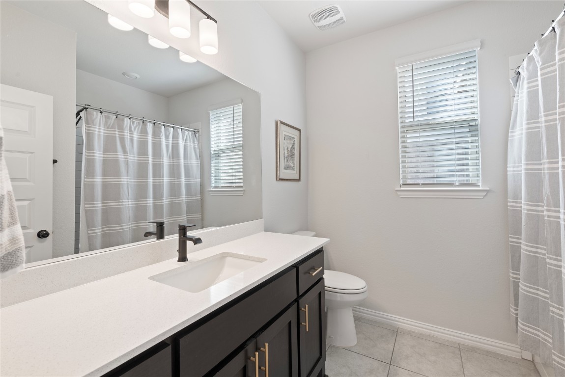 261 Fawn Riv Run Kyle, TX 78640 - Photo 15 of 40 a bathroom with a sink a toilet and shower