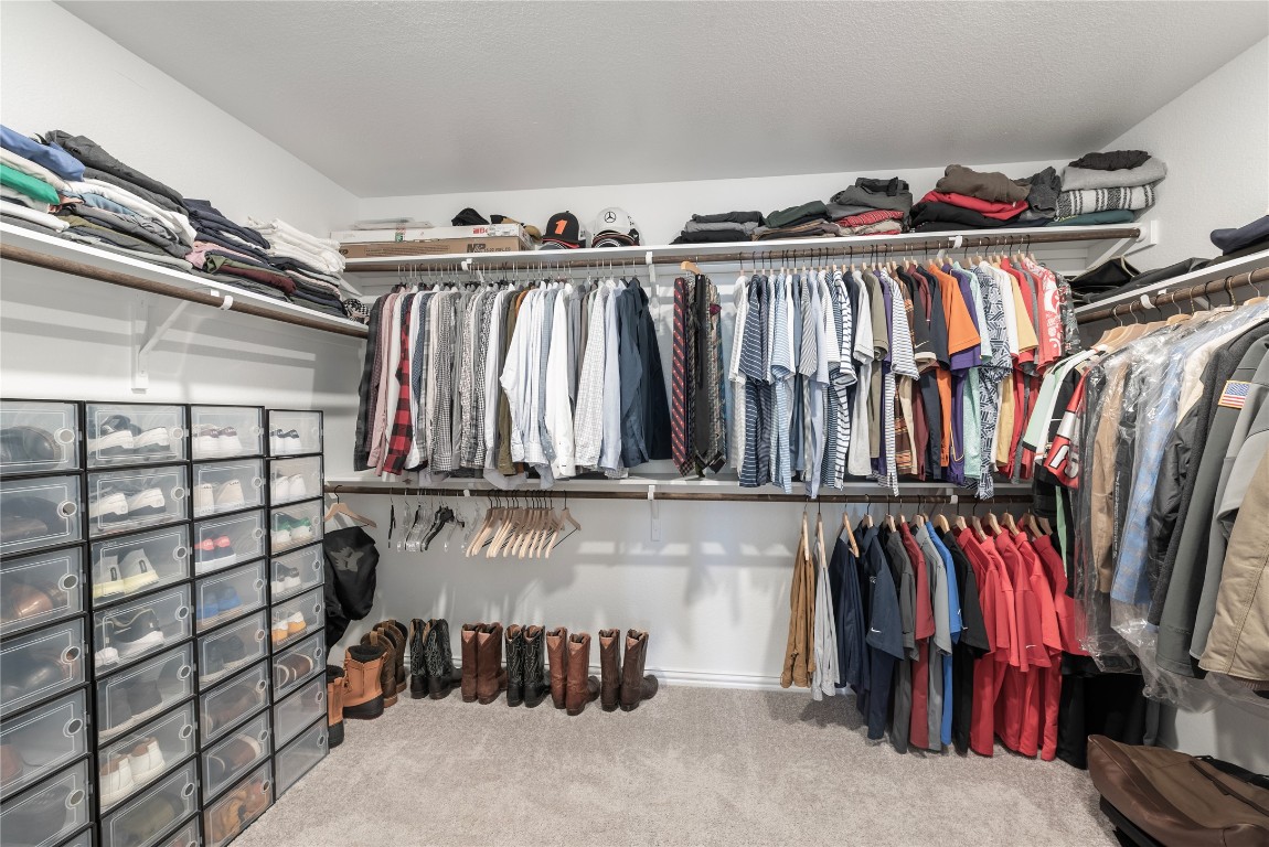261 Fawn Riv Run Kyle, TX 78640 - Photo 23 of 40 a view of walk in closet with clothes and shoes
