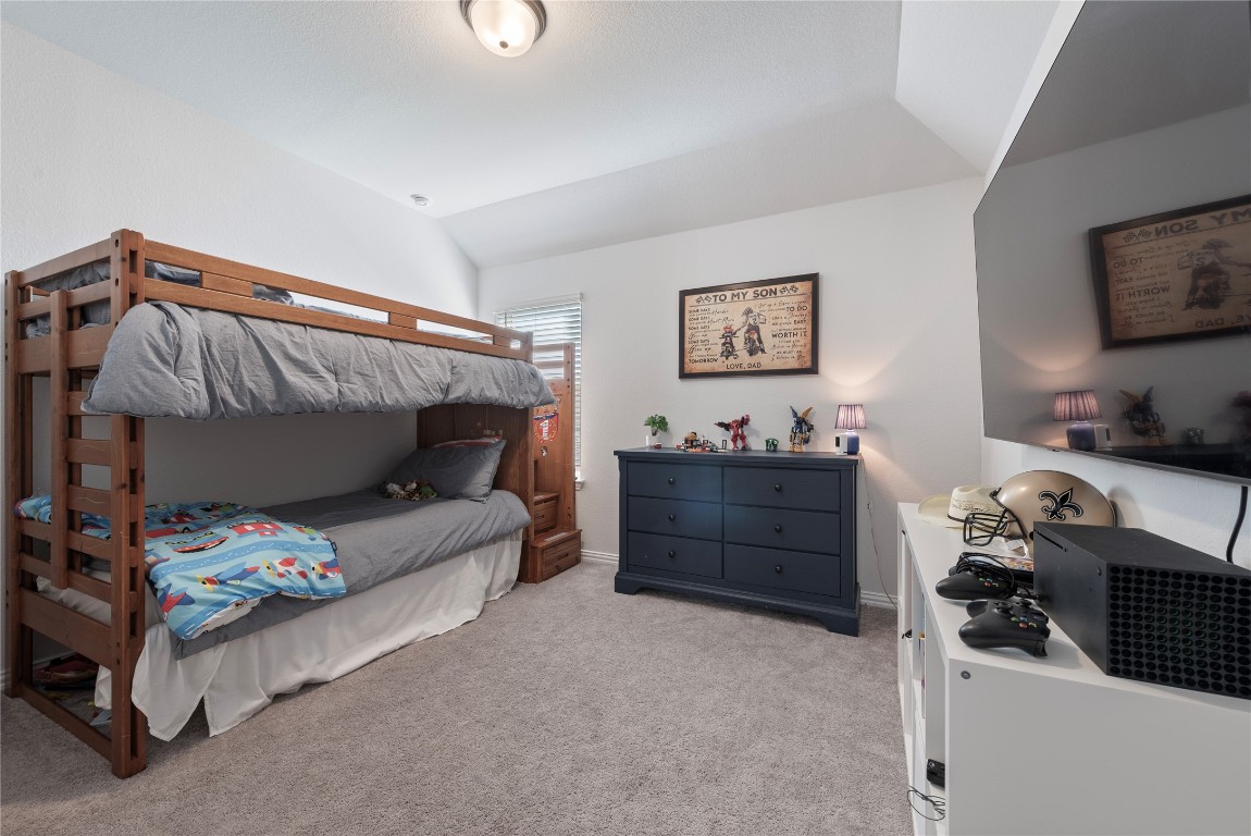 261 Fawn Riv Run Kyle, TX 78640 - Photo 26 of 40 a bedroom with a bed and a tv