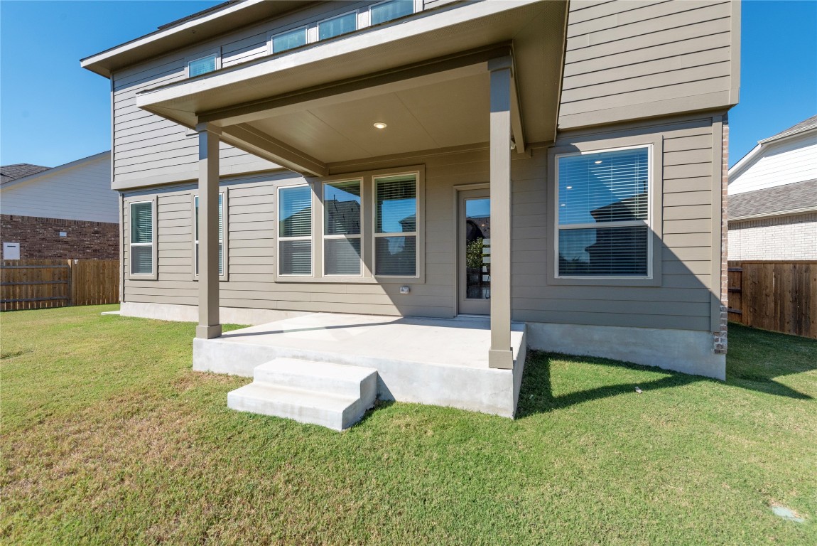 261 Fawn Riv Run Kyle, TX 78640 - Photo 30 of 40 a view of a house with backyard and porch