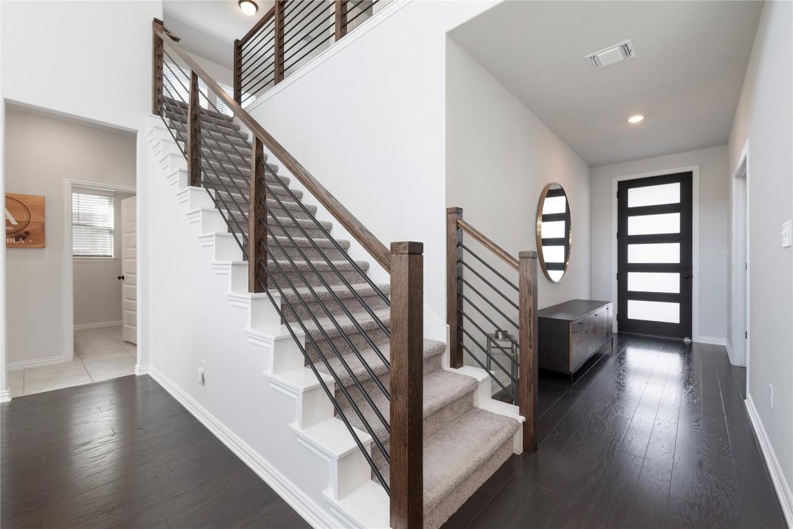 261 Fawn Riv Run Kyle, TX 78640 - Photo 3 of 40 a view of entryway with stairs and wooden floor