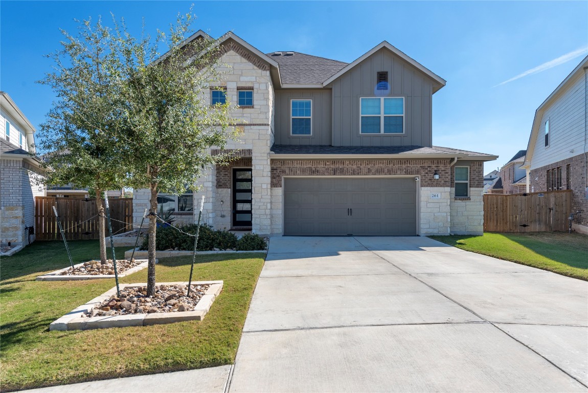 261 Fawn Riv Run Kyle, TX 78640 - Photo 34 of 40 a front view of a house with a yard and garage
