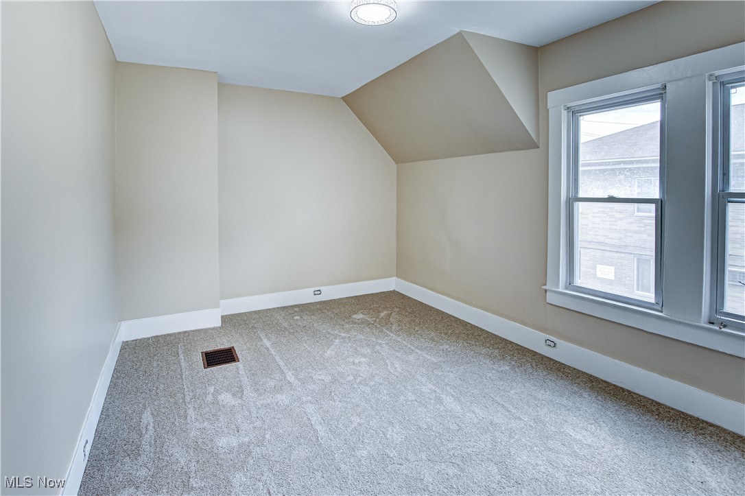 3877 Riveredge Road Cleveland, OH 44111 - Photo 21 of 27 Additional living space with light carpet and lofted ceiling