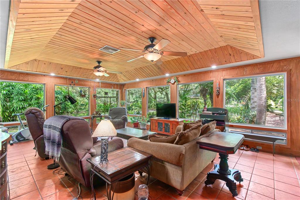 17840 Northeast 45th Avenue Road Citra, FL 32113 - Photo 13 of 62 a outdoor space with patio the couches and a dining table with the garden view