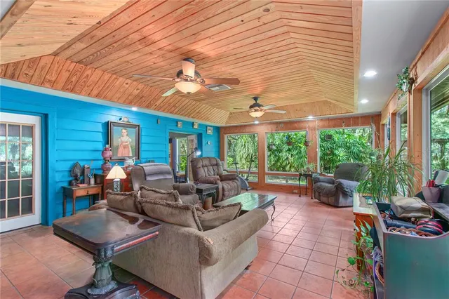 a living room with lots of furniture and a book shelf