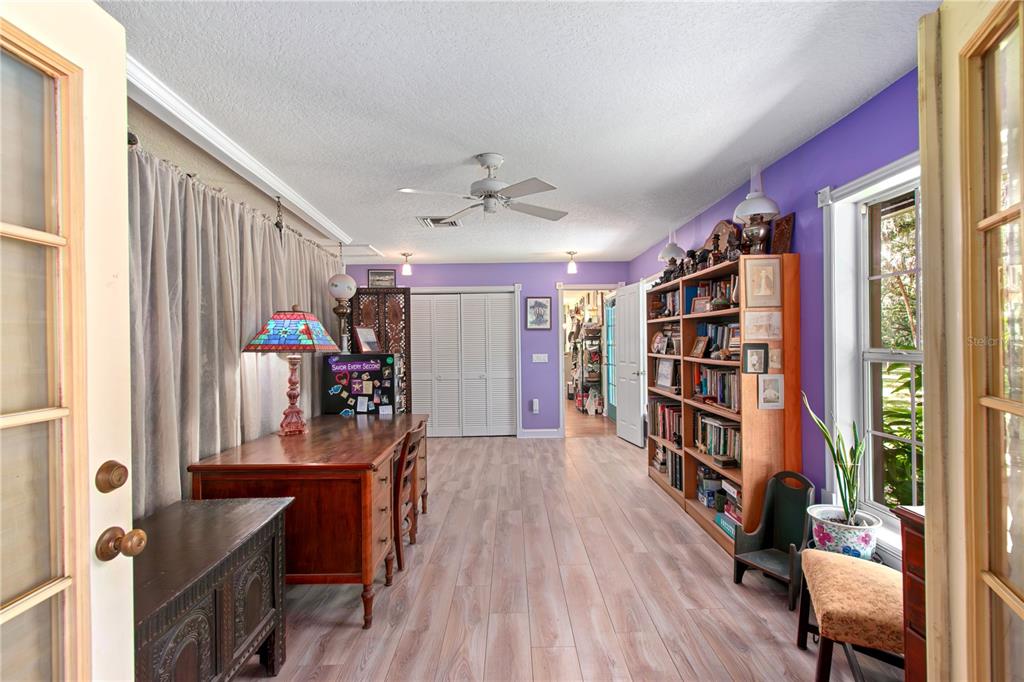 17840 Northeast 45th Avenue Road Citra, FL 32113 - Photo 16 of 62 a view of a workspace with furniture and a book shelf