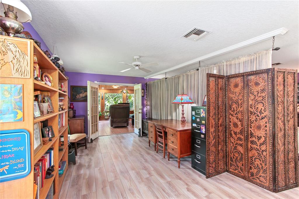 17840 Northeast 45th Avenue Road Citra, FL 32113 - Photo 17 of 62 a living room with lots of furniture and a book shelf