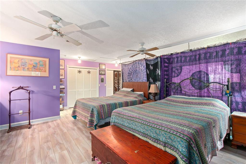 17840 Northeast 45th Avenue Road Citra, FL 32113 - Photo 18 of 62 a bedroom with bed and wooden floor