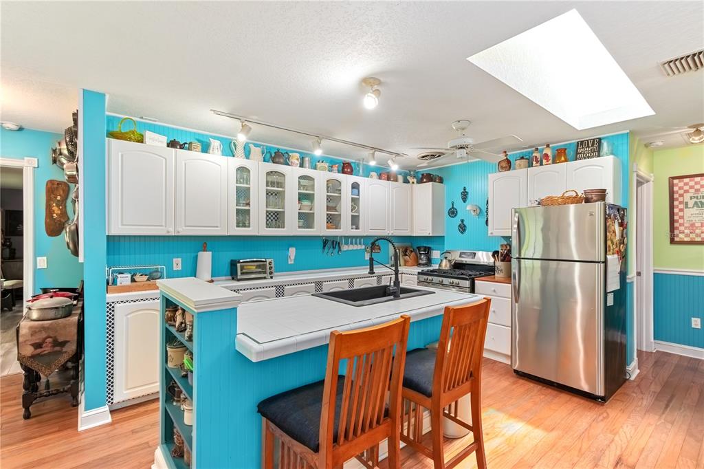 17840 Northeast 45th Avenue Road Citra, FL 32113 - Photo 21 of 62 a kitchen with stainless steel appliances granite countertop a refrigerator a sink a stove a dining table and chairs