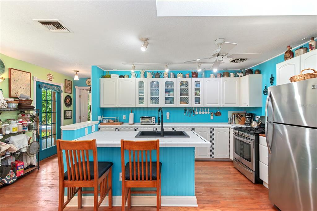 17840 Northeast 45th Avenue Road Citra, FL 32113 - Photo 22 of 62 a kitchen with stainless steel appliances granite countertop a refrigerator a stove top oven a dining table and chairs