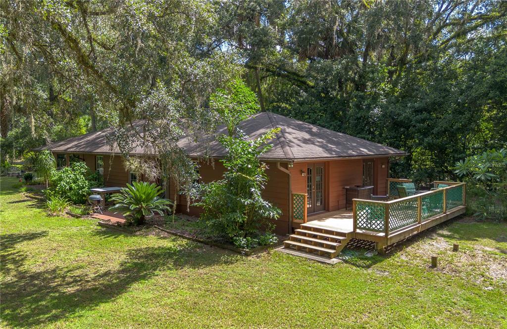17840 Northeast 45th Avenue Road Citra, FL 32113 - Photo 10 of 62 a view of a house with a yard deck and furniture