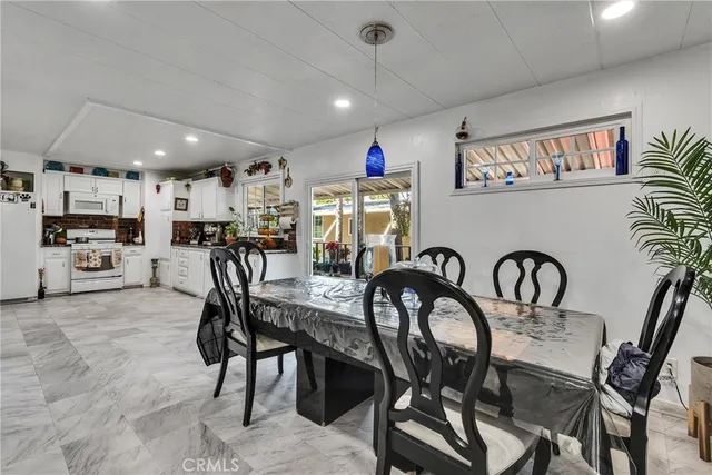 a dining room with furniture and chandelier