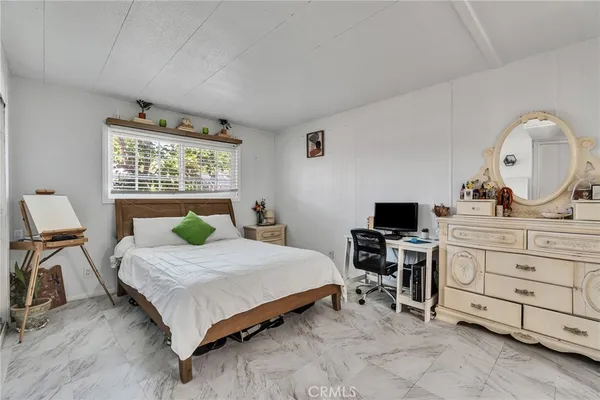 a bedroom with a bed and a desk