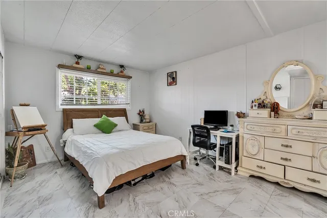 a bedroom with a bed and a desk