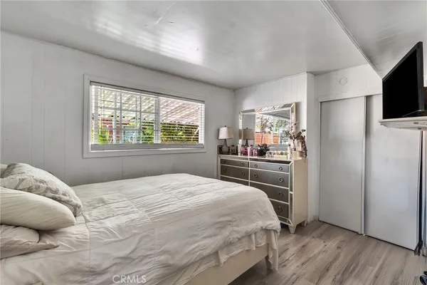 a bedroom with a bed and a large window