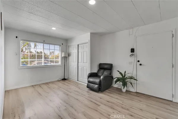 a view of a room with wooden floor