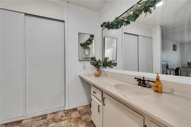 a bathroom with a sink double vanity and a mirror