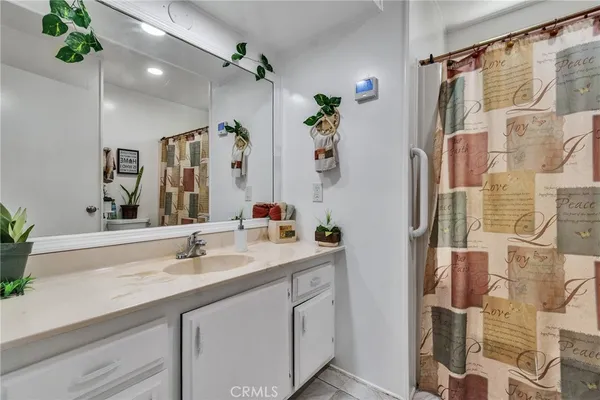 a patio with a table and chairs under an umbrella