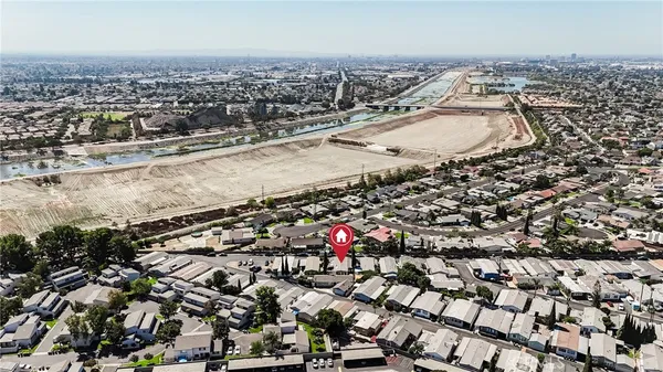 an aerial view of residential houses with city view