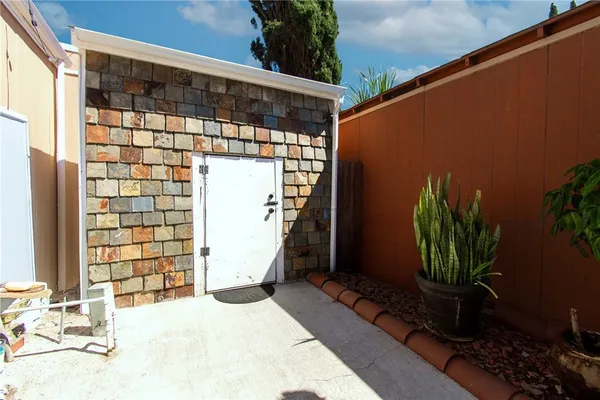 a backyard of a house with potted plants