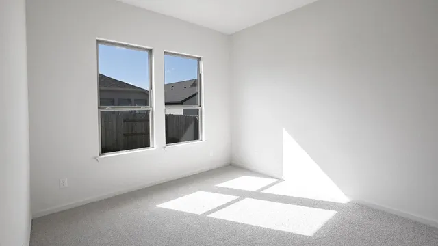 a view of an empty room with windows
