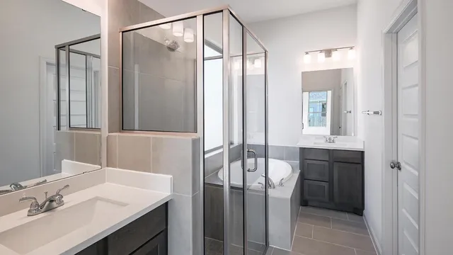 a bathroom with a tub sink and mirror