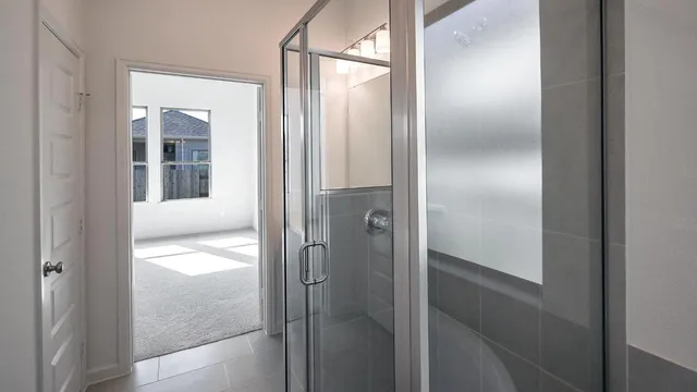 a bathroom with a glass shower door