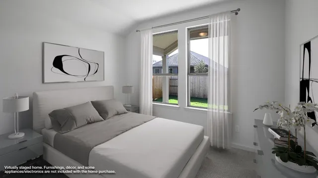 a bedroom with a bed and a flat tv screen