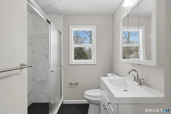 a bathroom with a sink toilet and shower