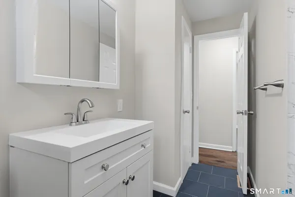 a bathroom with a sink and a mirror
