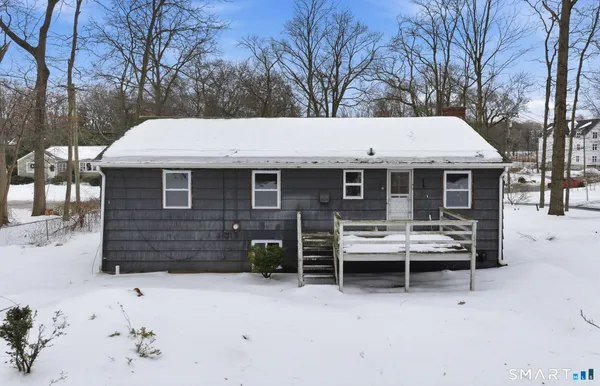 a view of a house with a yard and tree s