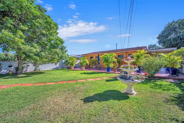 a view of yard with swimming pool and green space