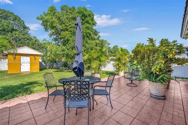 a view of a backyard with a sitting area