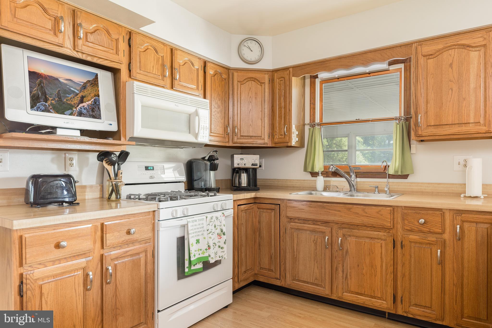 1250 Centerton Road Elmer, NJ 08318 - Photo 6 of 23 a kitchen with stainless steel appliances granite countertop a sink and cabinets with wooden floor