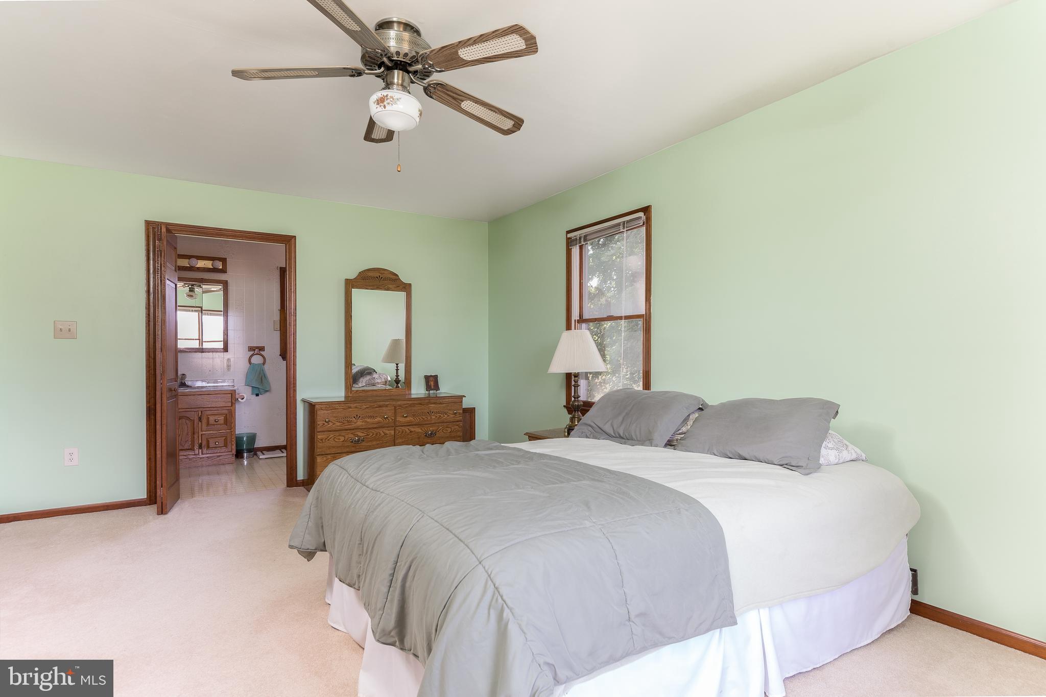 1250 Centerton Road Elmer, NJ 08318 - Photo 10 of 23 a bedroom with a bed and a chandelier