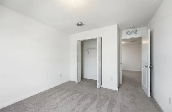 a view of an empty room and closet in a room