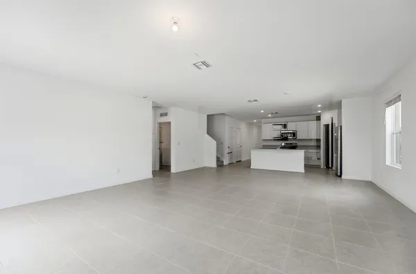 a view of kitchen with furniture and refrigerator